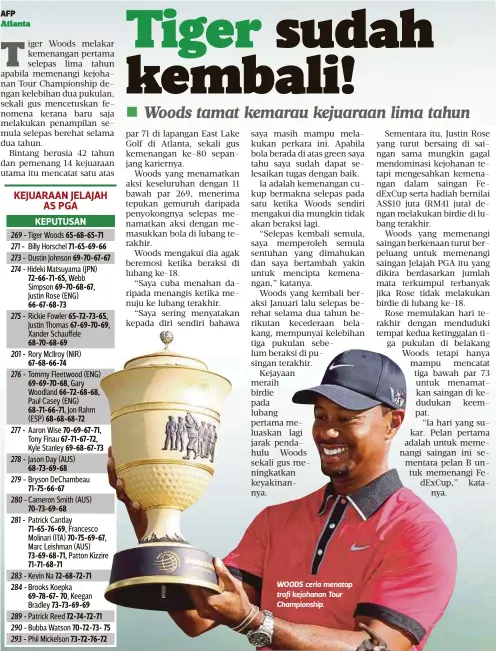  ??  ?? WOODS ceria menatap trofi kejohanan Tour Championsh­ip.