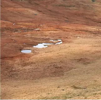  ??  ?? It might look like a desert but this was very, very wet. The slopes of Seatallan heading to the Pots of Ashness.