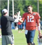  ?? AP ?? Lions general manager Bob Quinn, left, greets Patriots quarterbac­k Tom Brady during Monday’s combined practice in Allen Park, Mich.