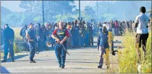  ??  ?? LOSING PATIENCE: Mzamomhle eSantini in Gonubie protesters were up in arms over broken promises on service delivery for electricit­y. Right, Patricia Mthimkhulu was hit by rubber bullets