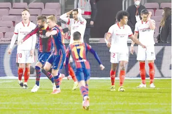  ?? - AFP photo ?? Barcelona’s Spanish defender Gerard Pique (2L) celebrates after scoring his team’s second goal against Sevilla FC at the Camp Nou stadium in Barcelona.