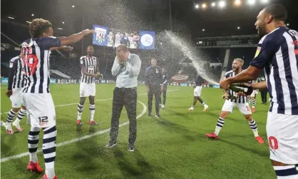  ??  ?? Slaven Bilic is soaked in champagne after West Brom won promotion back to the Premier League in July. Photograph: Adam Fradgley/ AMA/West Bromwich Albion FC/Getty Images