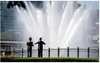  ?? JIM NOELKER / STAFF ?? Dayton tourism numbers have dropped because of COVID-19, but Miami Valley residents can still take in sites, such as the Wilbur and Orville Wright statues watching the fountains at Deeds Park.