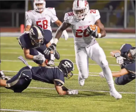  ?? SAM STEWART — DIGITAL FIRST MEDIA ?? Wilson’s Iggy Reynoso leaves Spring-Ford defenders behind en route to a 64-yard touchdown in the second quarter.