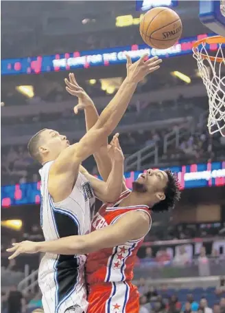  ?? CHARLES KING/STAFF PHOTOGRAPH­ER ?? Magic F Aaron Gordon goes up to score over 76ers F Jahlil Okafor during Sunday’s game at Amway Center. Gordon finished with 22 points on 7-of-10 shooting and grabbed 7 rebounds in the Magic’s victory.