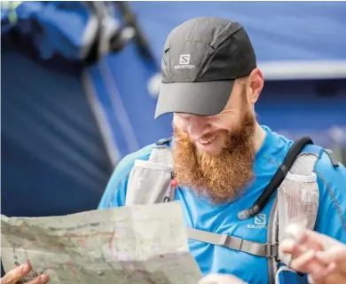  ??  ?? OPPOSITE Race founder/director Gary“Lazarus Lake” Cantrell accepts his first Newfoundla­nd license plate as part of Robbins’ entry fee
ABOVE Gary Robbins joined the Greater Vancouver Orienteeri­ng Club to help hone his navigating skills