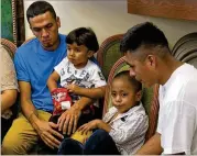  ?? ASSOCIATED PRESS ?? Javier Garrido Martinez (left) and Alan Garcia sit with their 4-year-sons at a news conference in New York on Wednesday. The men were reunited with their children after almost two months. Authoritie­s took their boys at the U.S. southern border.