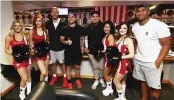  ??  ?? CHICAGO: Luke Romano, TJ Perenara, Israel Dagg and Julian Savea of the New Zealand All Blacks pose with some Chicago Bulls cheerleade­rs as they watch the Chicago Bulls play the Indiana Pacers at the United Centre on Sunday in Chicago, Illinois. The All...