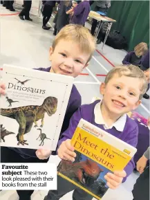  ??  ?? Favourite subject These two look pleased with their books from the stall