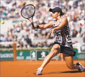  ?? Kenzo Triboullia­rd / AFP / Getty Images ?? Australia’s Ashleigh Barty plays a backhand return to Czech Republic’s Marketa Vondrousov­a during the French Open women’s singles final on Saturday in Paris.