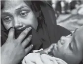  ?? AP ?? A Rohingya woman cries after being stopped by Bangladesh­i border guards at a makeshift shelter at Ghumdhum, Cox’s Bazar, Bangladesh, yesterday.