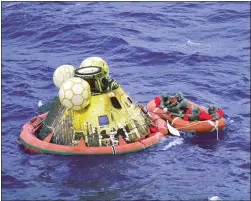  ?? NASA PHOTO ?? Crew members prepare to assist the Apollo 11astronau­ts after their capsule splashed down in the Pacific, 900miles southwest of Hawaii, on July 24, 1969.