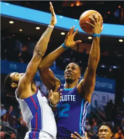  ?? (Reuters) ?? CHARLOTTE HORNETS center Dwight Howard (12) shoots over Detroit Pistons defender Andre Drummond for two of his 17 points in the Hornets’ 114-98 home conquest of the Pistons on Sunday night – Charlotte’s season-best fourth win in a row.