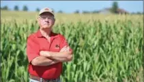  ?? CHRIS SETO, GUELPH MERCURY ?? Alex Lush stands on Third Line near his farm equipment business with his back to the site of one of the first suspicious fires reported in the area by the Wellington County OPP.