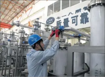  ?? PROVIDED TO CHINA DAILY ?? A worker measures the pressure in a gas tank at a manufactur­ing plant of the 718th Research Institute.