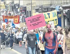  ?? LESLEY MARTIN — PA VIA AP ?? Scotland United Against Trump demonstrat­ors march through the Edinburgh during a “Carnival of Resistance” to protest against the visit of the president Saturday.