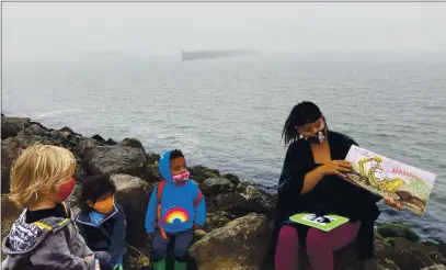  ?? COURTESY OF BERKELEY FOREST SCHOOL ?? ABOVE: Students at the Berkeley Forest School have story time by the bay. Forest schools are an immersive outdoor education model devoted to the exploratio­n of nature. BELOW: Berkeley Forest School students explore rocks and crevices along the bay’s edge.