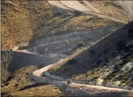  ?? MATT YORK—ASSOCIATED PRESS ?? A pathway cleared by explosives to make way for border wall constructi­on separates Mexico, right, and the United States, Wednesday, Dec. 9, 2020, in Guadalupe Canyon, Ariz. President Biden on Wednesday ordered a “pause” on all wall constructi­on within a week, one of 17 executive edicts issued on his first day in office, including six dealing with immigratio­n. The order leaves projects across the border unfinished and under contract after Trump worked feverishly last year to reach 450 miles, a goal he announced was achieved eight days before leaving office.