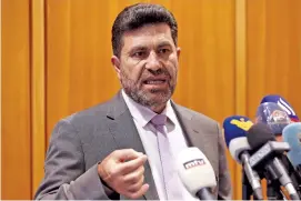  ?? AP PHOTO/HUSSEIN MALLA ?? Lebanon’s Energy Minister Raymond Ghajjar, speaks to journalist­s upon his arrival from Iraq at Rafik Hariri internatio­nal airport after he signed an agreement with the Iraqi government in Beirut, Lebanon, on Saturday.