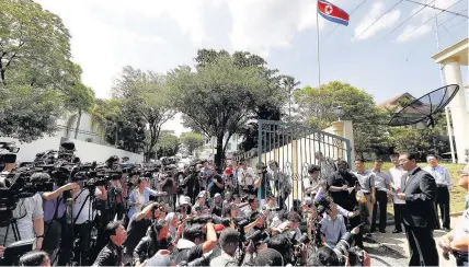  ??  ?? > North Korea’s Ambassador to Malaysia Kang Chol, right, speaks to the media outside the North Korean Embassy in Kuala Lumpur, Malaysia,yesterday