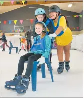  ?? ?? Hayley Twaddle, 10, and Tevani Mose, 9, push 10-year-old Sienna Farrell around the rink.