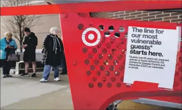  ?? Nam Y. Huh Associated Press ?? SEVERAL Shipt delivery workers say Target’s move from a commission-based model to a new pay algorithm has significan­tly cut their earnings. Above, shoppers wait to enter a Target in Glenview, Ill., last month.