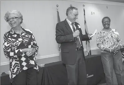  ?? SUBMITTED PHOTOS ?? College of Southern Maryland Trustees Chair Dorothea Smith, left, and Tony Jernigan, vice president of financial and administra­tive services, laugh during Jernigan’s commendati­on of Annie Jackson and her 20 years of service at CSM.