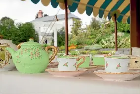  ??  ?? Tea party food on the outdoors banquet table have been fashioned from concrete and resin.