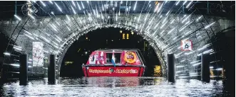  ?? PETER DEJONG/ THE ASSOCIATED PRESS ?? A canal cruise boat passes under art work, part of the sixth edition of the Amsterdam Light Festival in Amsterdam. The city is considerin­g a variety of changes to tame rampant tourism.