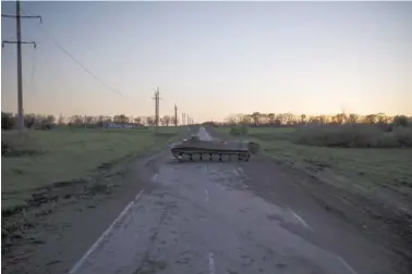  ?? AP PHOTO/FELIPE DANA ?? A destroyed Russian tank sits in a road Monday in the village of Vilkhivka, recently retaken by Ukraininan forces near Kharkiv, Ukraine.