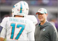  ?? Jeff Haynes / Associated Press ?? Miami Dolphins head coach Adam Gase talks with quarterbac­k Ryan Tannehill before a game against the Minnesota Vikings on Dec. 16 in Minneapoli­s. Gase will be introduced as the coach of the New York Jets onMonday.