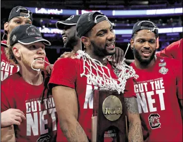  ?? ELSA / GETTY IMAGES ?? Sindarius Thornwell (center), MVP of the East Region, scored 26 in the final and is the top scorer left in the tournament at 25.8 a game. He says the Gamecocks’ motto has been “no matter the outcome of anything, don’t let go of that rope.”