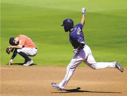  ?? GREGORY BULL AP ?? The Rays’ Manuel Margot rounds the bases past the Astros’ Jose Altuve after hitting a three-run home run in the first inning Monday.