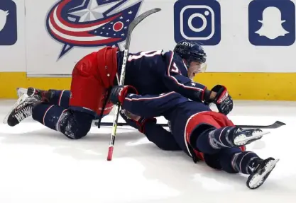  ?? Paul Vernon, The Associated Press ?? Columbus forward Yegor Chinakhov, top, celebrates with Gavin Bayreuther after teammate Cole Sillinger’s goal against the Avalanche during the third period.