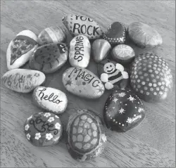  ?? Submitted photos ?? Left: Emily Burtwell of South Attleboro shows a Riverside Rocks painted rock she found at Wawaloam Campground in Exeter. Right, below: A photo of some of the rocks that have been hidden by the group.