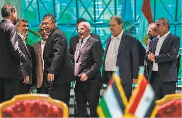  ?? Khaled Desouki / AFP / Getty Images ?? Hamas, Fatah and Egyptian officials smile following the signing of a reconcilia­tion deal in Cairo.