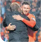  ??  ?? Calum Butcher is congratula­ted by his manager, Robbie Neilson