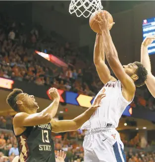  ?? RYAN M. KELLY/GETTY IMAGES ?? Virginia’s Braxton Key rebounds past Anthony Polite during the Cavaliers’ home game against Florida State earlier this season. Key scored 20 points in the Cavaliers’ win over FSU.