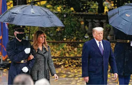  ?? Patrick Semansky / Associated Press ?? Donald Trump and first lady Melania Trump observe Veterans Day at Arlington National Cemetery in Virginia on Wednesday.