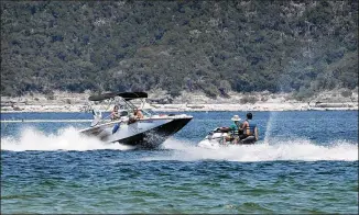  ?? JAY JANNER / AMERICAN-STATESMAN ?? Boaters enjoy Lake Travis near Mansfield Dam Park on Wednesday. Meteorolog­ist Bob Rose said temperatur­es in Central Texas will likely average 1 to 2 degrees warmer than normal from late spring through summer. Rainfall is expected to approach 30-year...