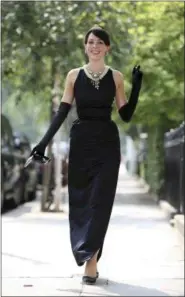  ?? CHRISTOPHE­R PLEDGER — THE ASSOCIATED PRESS FILE ?? Model Romilly Collins wears the black Givenchy dress made for actress Audrey Hepburn in the classic 1961 film “Breakfast at Tiffany’s” in central London.