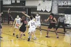  ??  ?? A GANG OF CRIMINALS SURROUND Dysart’s Colton Jett (10) as he attempts to drive down the lane during Saturday’s game at Yuma High.