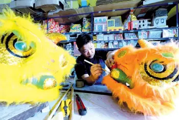 ??  ?? This Chinese New Year is particular­ly sad for lion dance outfit repairer Lu Tshun Yaw as none of the associatio­ns seek his service this year due to the Covid-19 SOP which disallows the popular festive performanc­es.