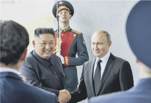  ??  ?? 0 Russian President Vladimir Putin, right, and North Korea’s leader Kim Jong -un pose for a photo before their talks in Vladivosto­k