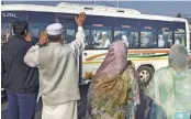  ?? — PTI ?? Relatives wave as Haj pilgrims leave for their pilgrimage to Mecca in Srinagar on Sunday.