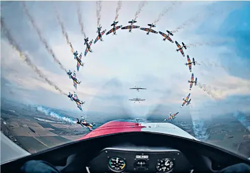  ??  ?? High flyers This astonishin­g image of the Flying Bulls, an Austrian fleet of historic aircraft, in mid-air acrobatics was taken from the cockpit of a participat­ing plane by the Czech photograph­er Daniel Vojtěch. It won the ‘Sequence’ category in the...