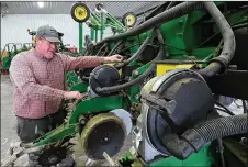  ??  ?? Clark County farmer Brian Harbage makes sure his planter is ready for better weather so he can start planting his crops.