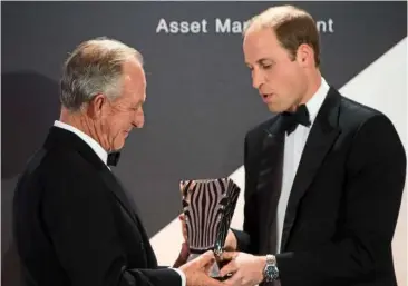  ??  ?? richard bonham (left) accepting the Prince William award for conservati­on in africa from Prince William, duke of cambridge at the Tusk conservati­on awards event in London last month. — aFP