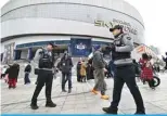  ?? ?? :,6<3! 7VSPJL VMÄJLYZ Z[HUK N\HYK PU MYVU[ VM [OL .Vcheok Sky Dome in Seoul on March 20, 2024, ahead of the 2024 MLB Seoul Series baseball game between Los Angeles Dodgers and San Diego Padres. – AFP