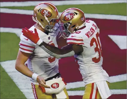  ?? ROSS D. FRANKLIN – THE ASSOCIATED PRESS ?? Running back Jeff Wilson, right, who rushed for 183 yards, celebrates his first-quarter touchdown catch with 49ers quarterbac­k C.J. Beathard.